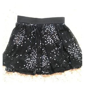 Flowy black skirt with small white flower design